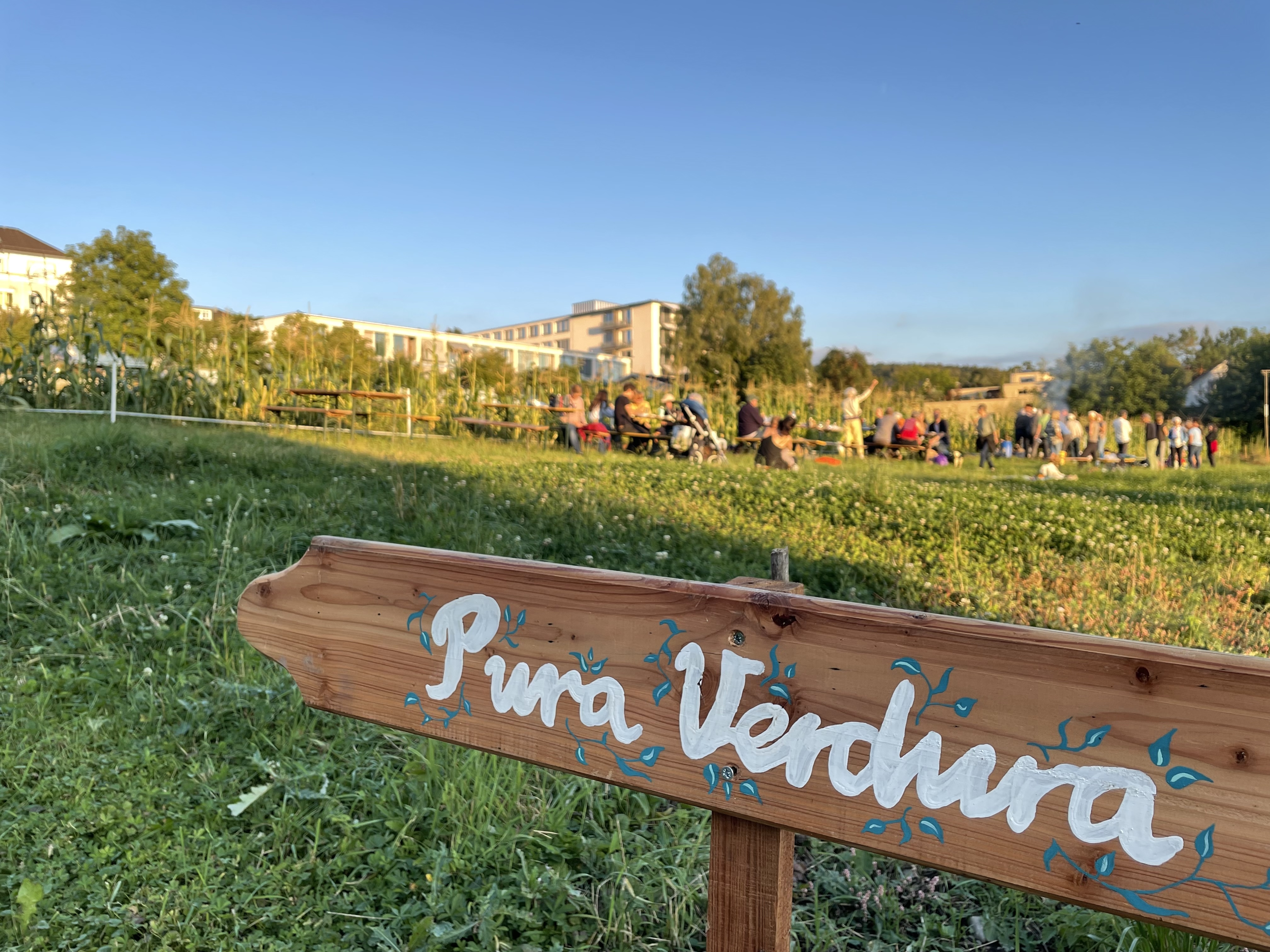 Acker mit Wegweiser-Schild im Vordergrund auf dem Pura Verdura steht